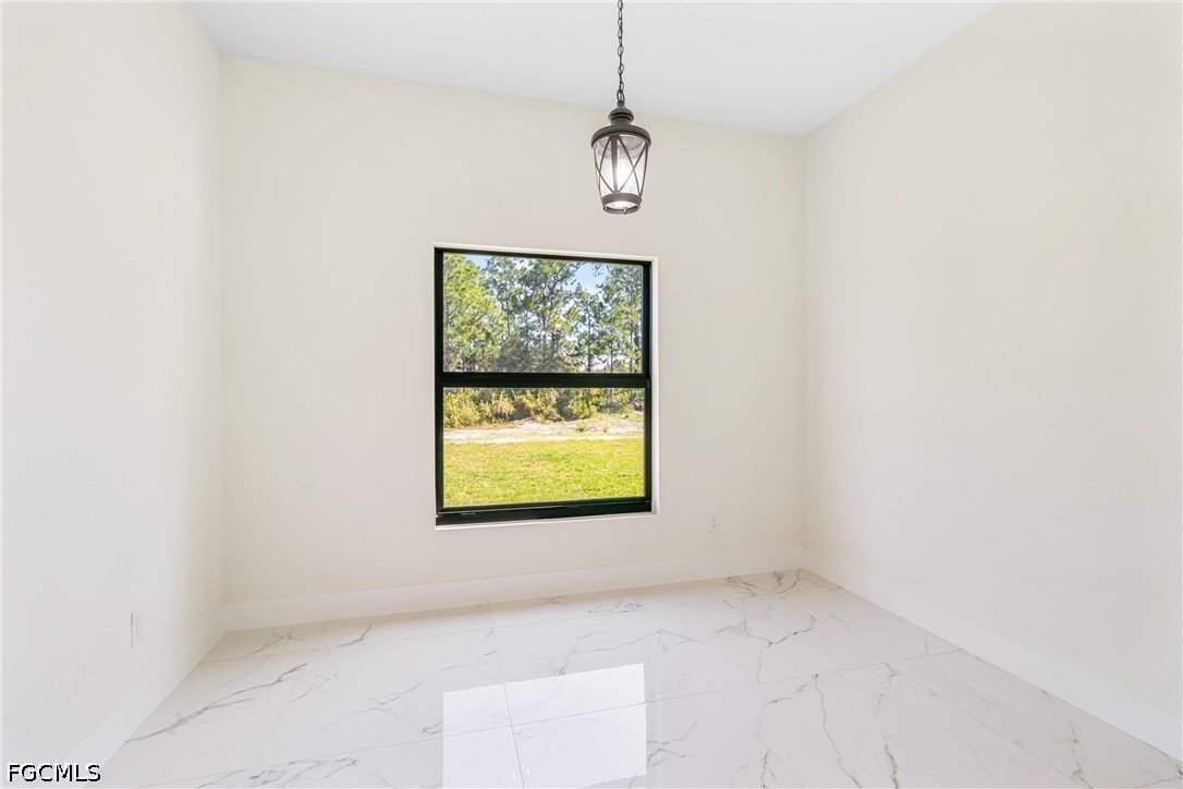 412 Fitch Avenue Lehigh Acres, FL 33972 - Photo 19 of 50 a view of an empty room with a window
