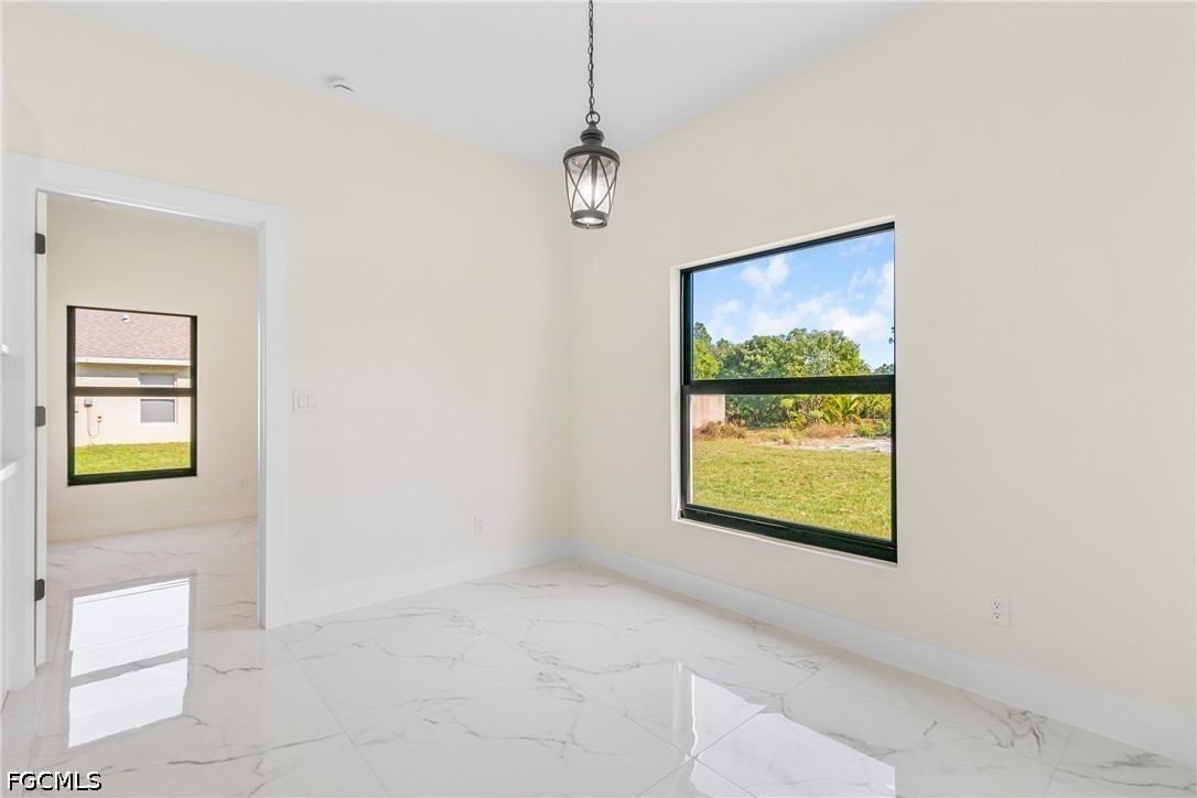 412 Fitch Avenue Lehigh Acres, FL 33972 - Photo 20 of 50 a view of an empty room with a window