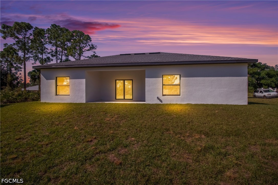 412 Fitch Avenue Lehigh Acres, FL 33972 - Photo 2 of 50 a front view of house with outdoor space and garden