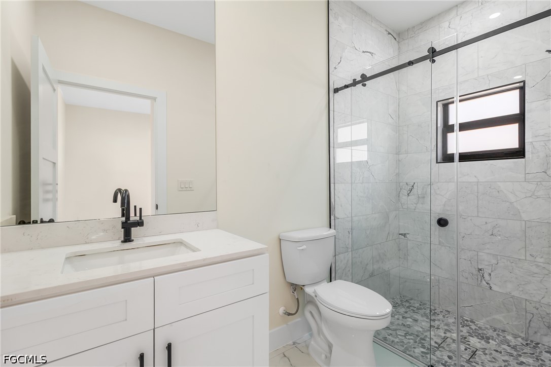 412 Fitch Avenue Lehigh Acres, FL 33972 - Photo 24 of 50 a bathroom with a sink toilet and shower