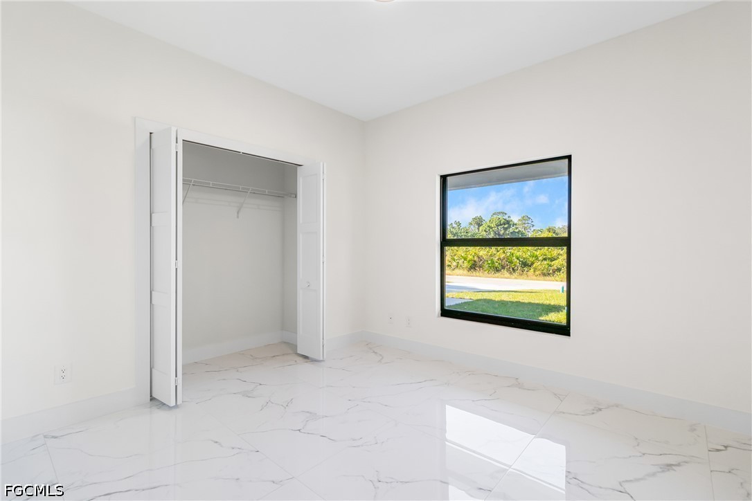 412 Fitch Avenue Lehigh Acres, FL 33972 - Photo 25 of 50 a view of an empty room and window
