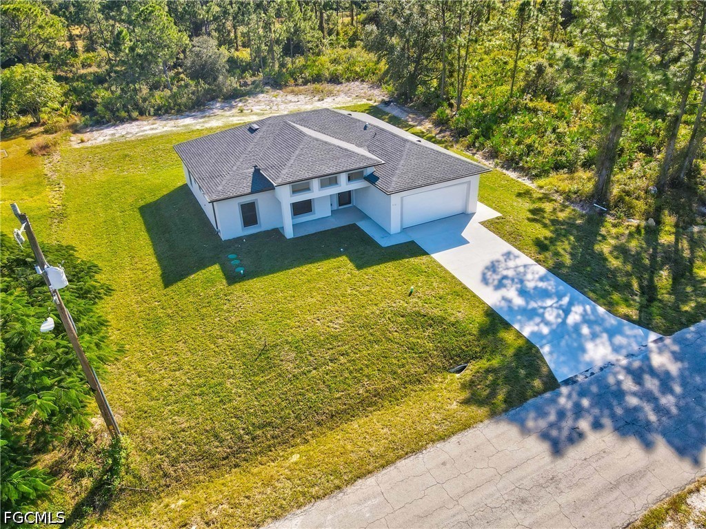 412 Fitch Avenue Lehigh Acres, FL 33972 - Photo 41 of 50 a view of a house with a yard