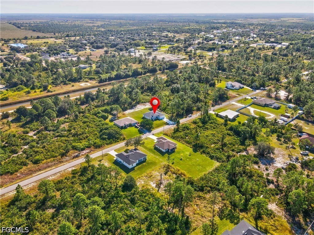 412 Fitch Avenue Lehigh Acres, FL 33972 - Photo 49 of 50 an aerial view of residential houses with outdoor space and trees