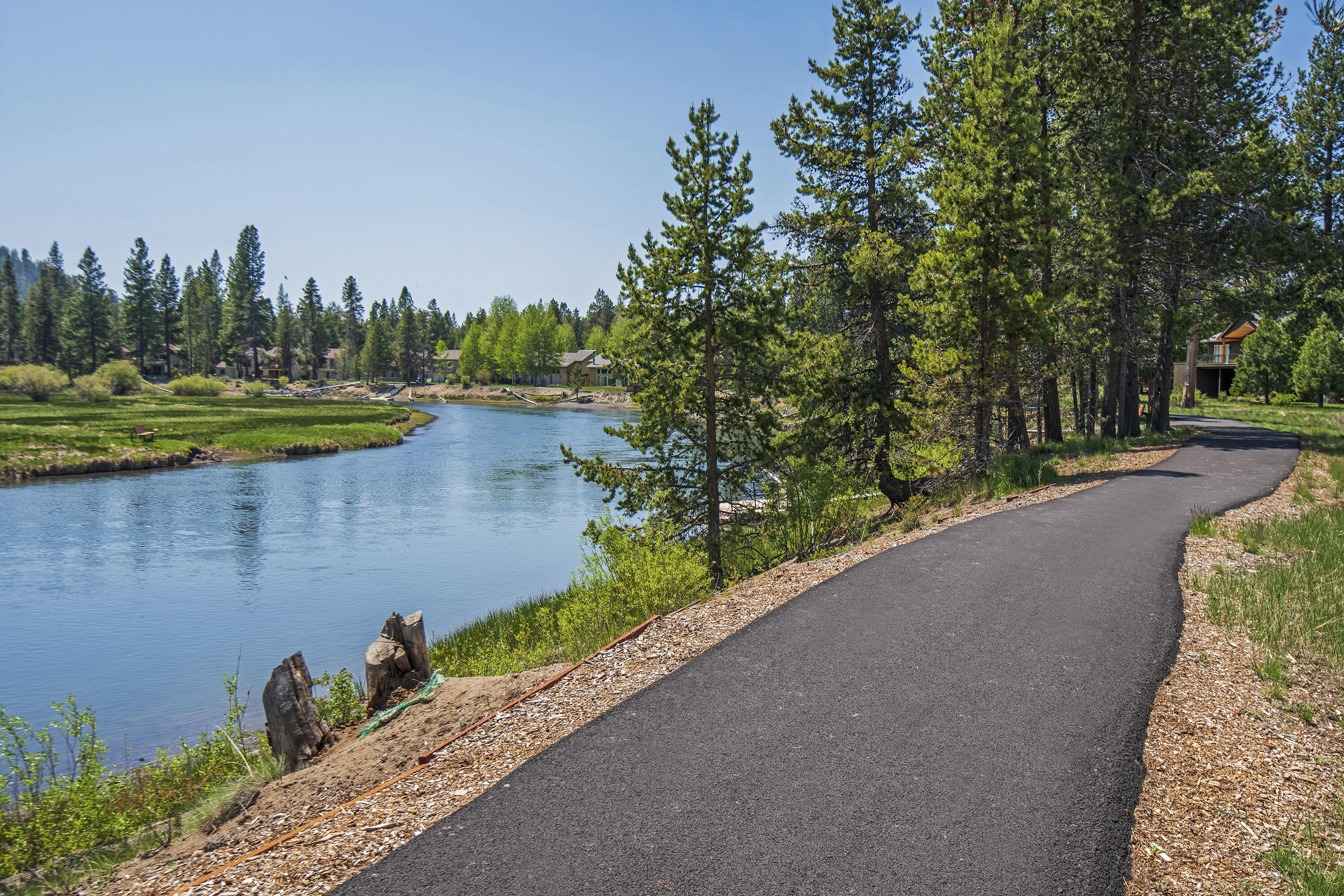 16775 Pony Express Way Bend, OR 97707 - Photo 32 of 38 a view of a lake with a yard and large trees