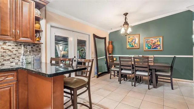 a dining room with furniture and chandelier