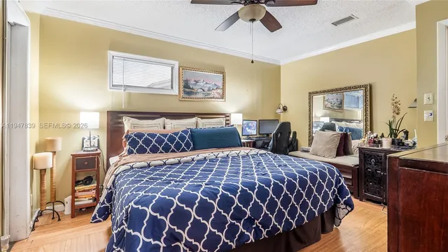 a bedroom with a large bed and a chandelier