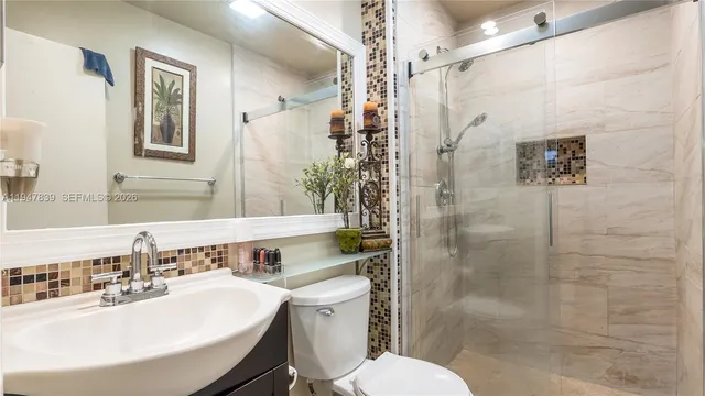 a bathroom with a sink toilet and shower