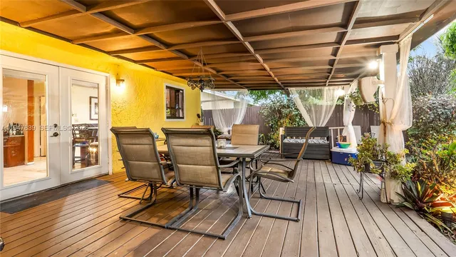 a view of a patio with table and chairs and wooden floor