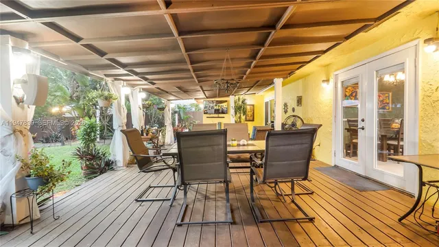a view of a patio with table and chairs and wooden floor