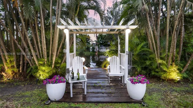a view of a chair and table in the garden