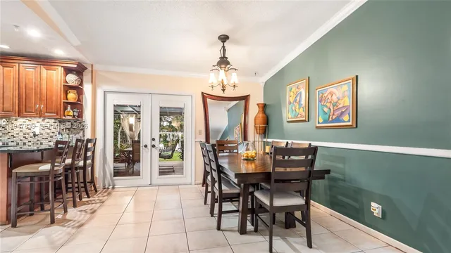 a dining room with furniture a chandelier and window