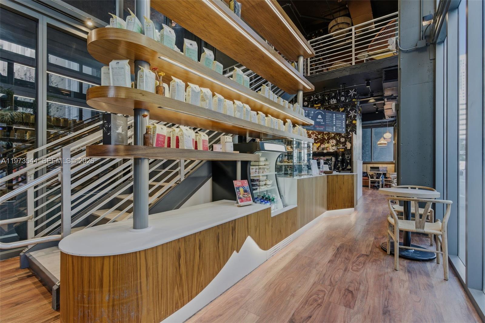 229 Southwest 9th Street, Unit 407 Miami, FL 33130 - Photo 11 of 29 a view of a balcony with chairs and wooden floor