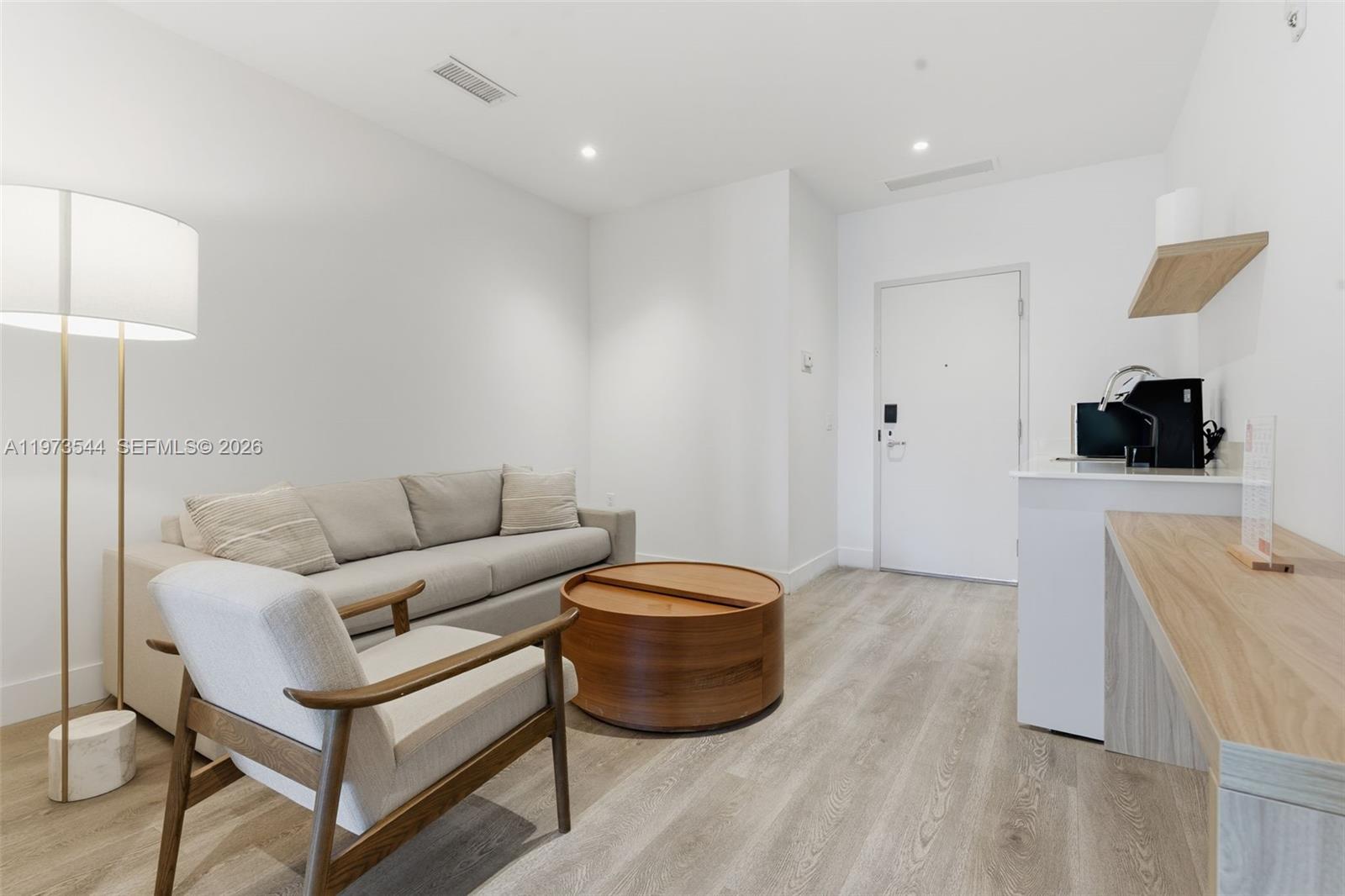229 Southwest 9th Street, Unit 407 Miami, FL 33130 - Photo 17 of 29 a living room with furniture and a flat screen tv