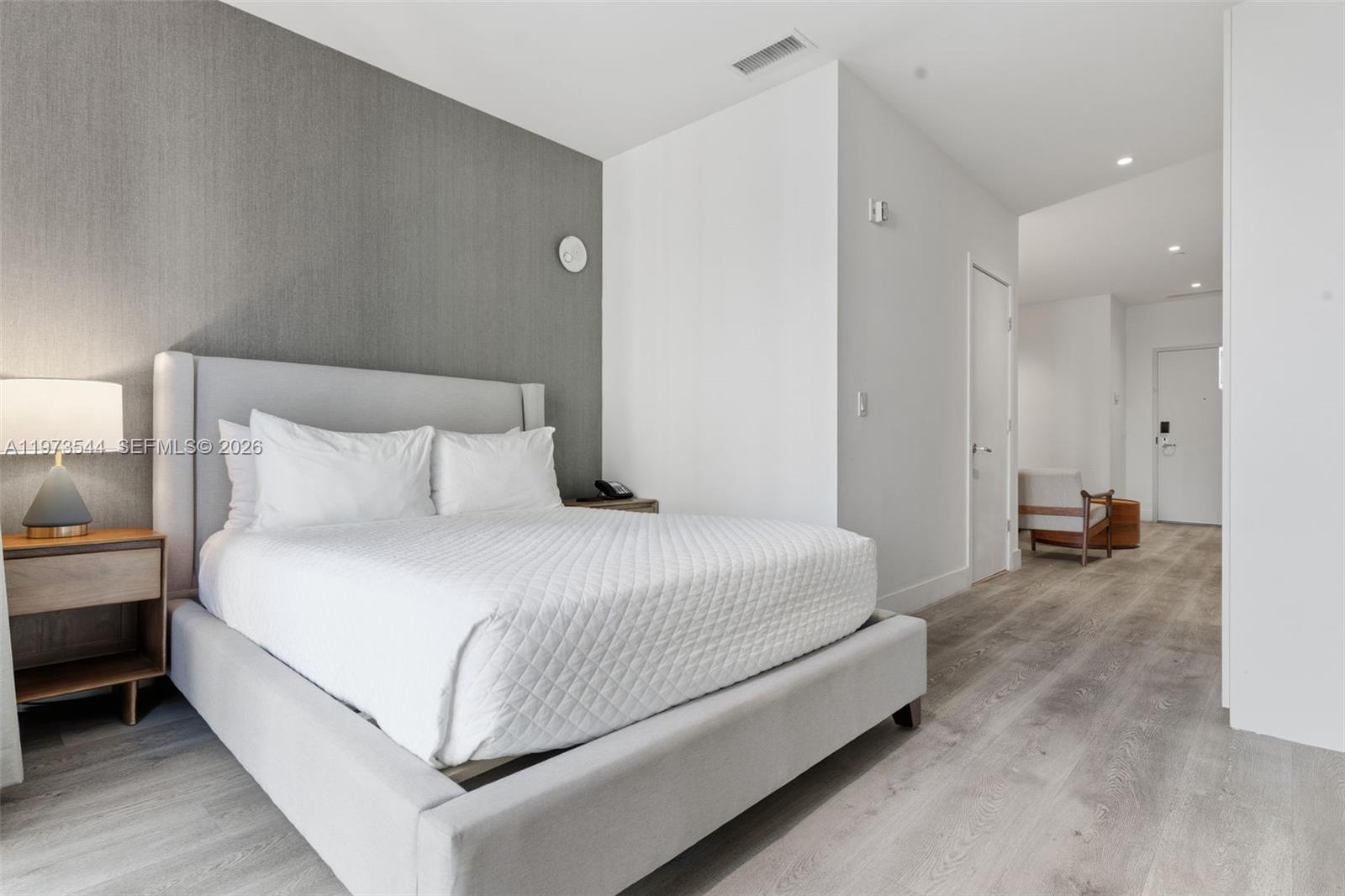 229 Southwest 9th Street, Unit 407 Miami, FL 33130 - Photo 20 of 29 a bedroom with bed and a couch