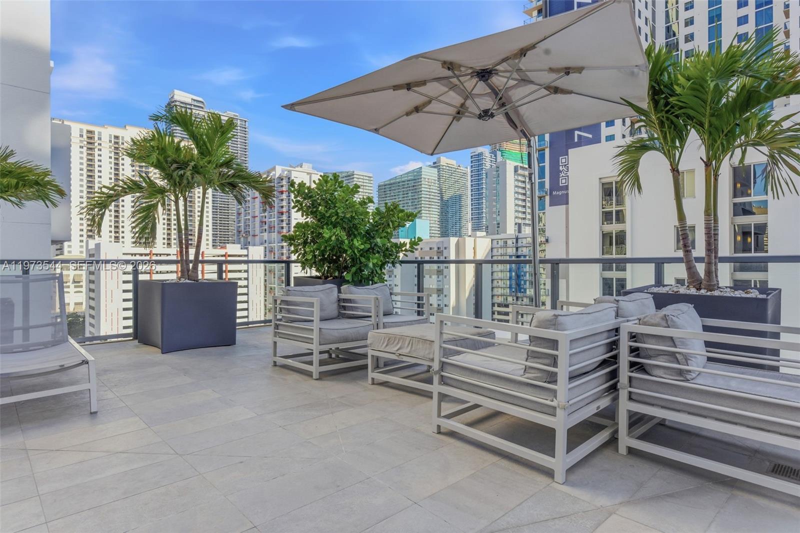229 Southwest 9th Street, Unit 407 Miami, FL 33130 - Photo 6 of 29 a view of a chair and tables in the patio