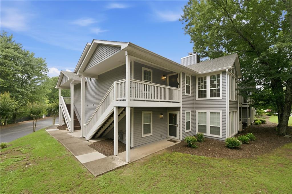1007 Olde Mill Lane Norcross, GA 30093 - Photo 4 of 32 a front view of a house with a yard