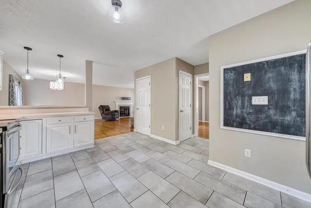 a open kitchen with cabinets and white appliances