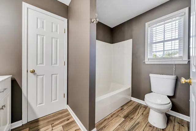 a white toilet sitting next to a bathroom sink