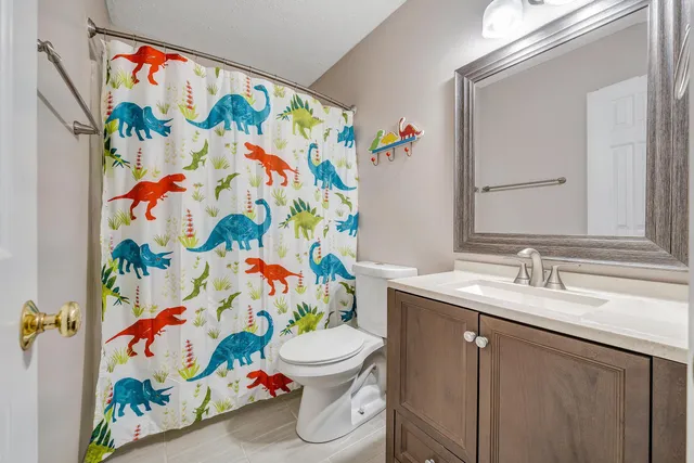 a bathroom with a sink a mirror and a shower curtain