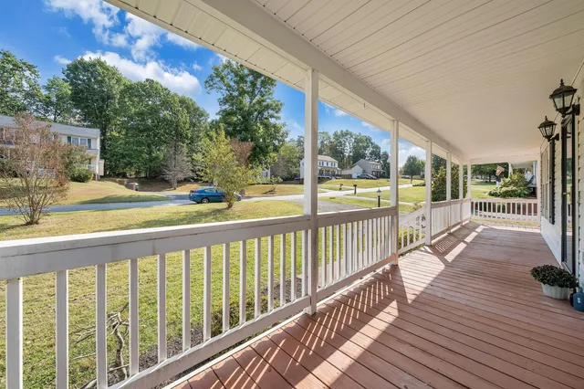 a view of a balcony with wooden floor