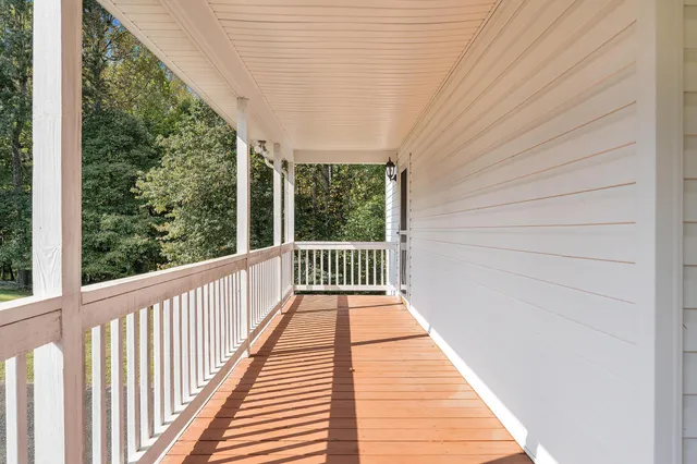 a view of balcony with wooden floor and outdoor seating