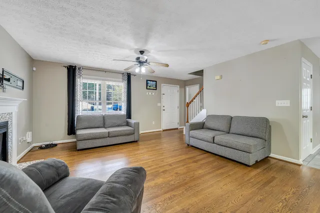 a living room with furniture and a fireplace