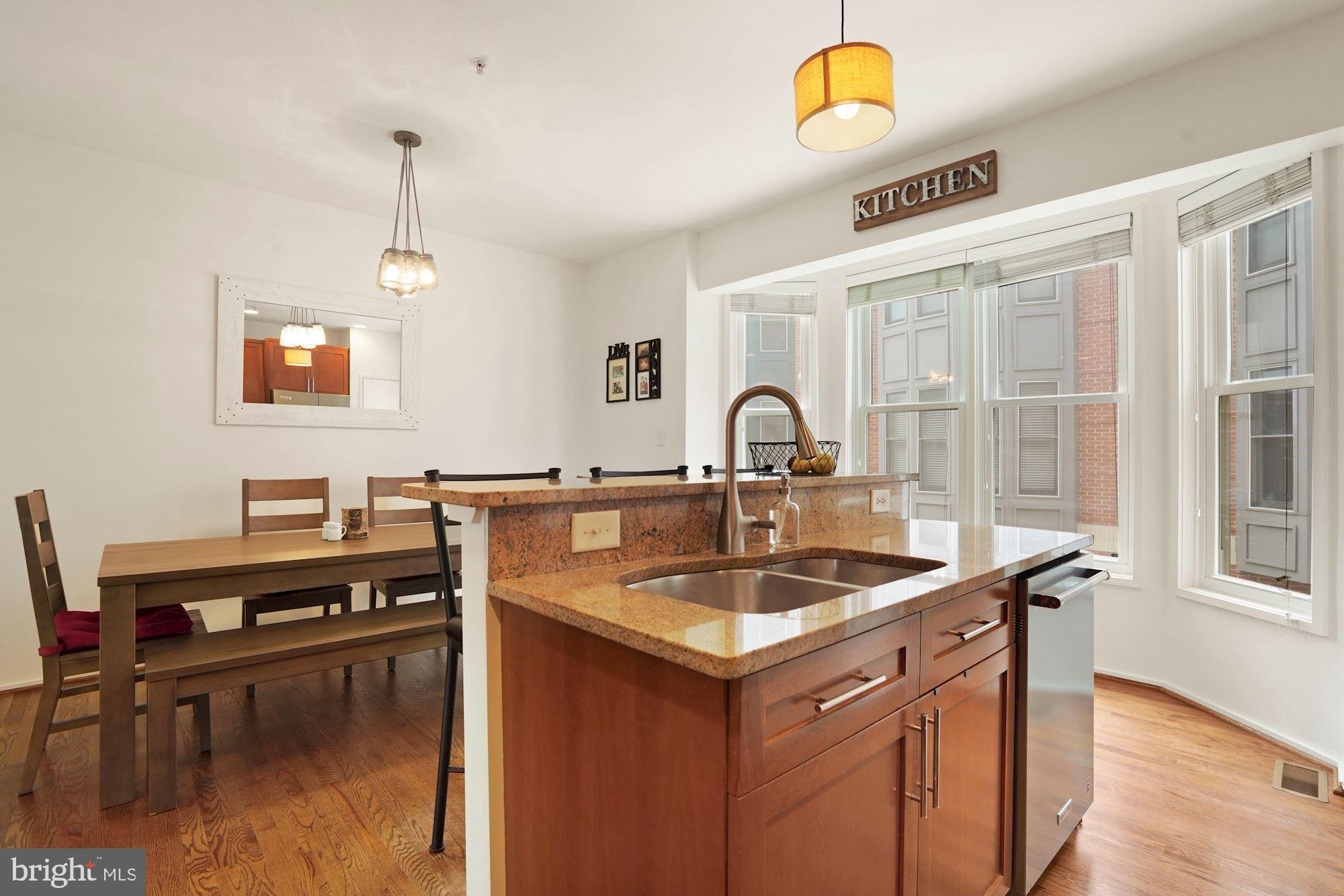 1618 North Rhodes Street Arlington, VA 22209 - Photo 13 of 33 a kitchen with a sink cabinets and a window
