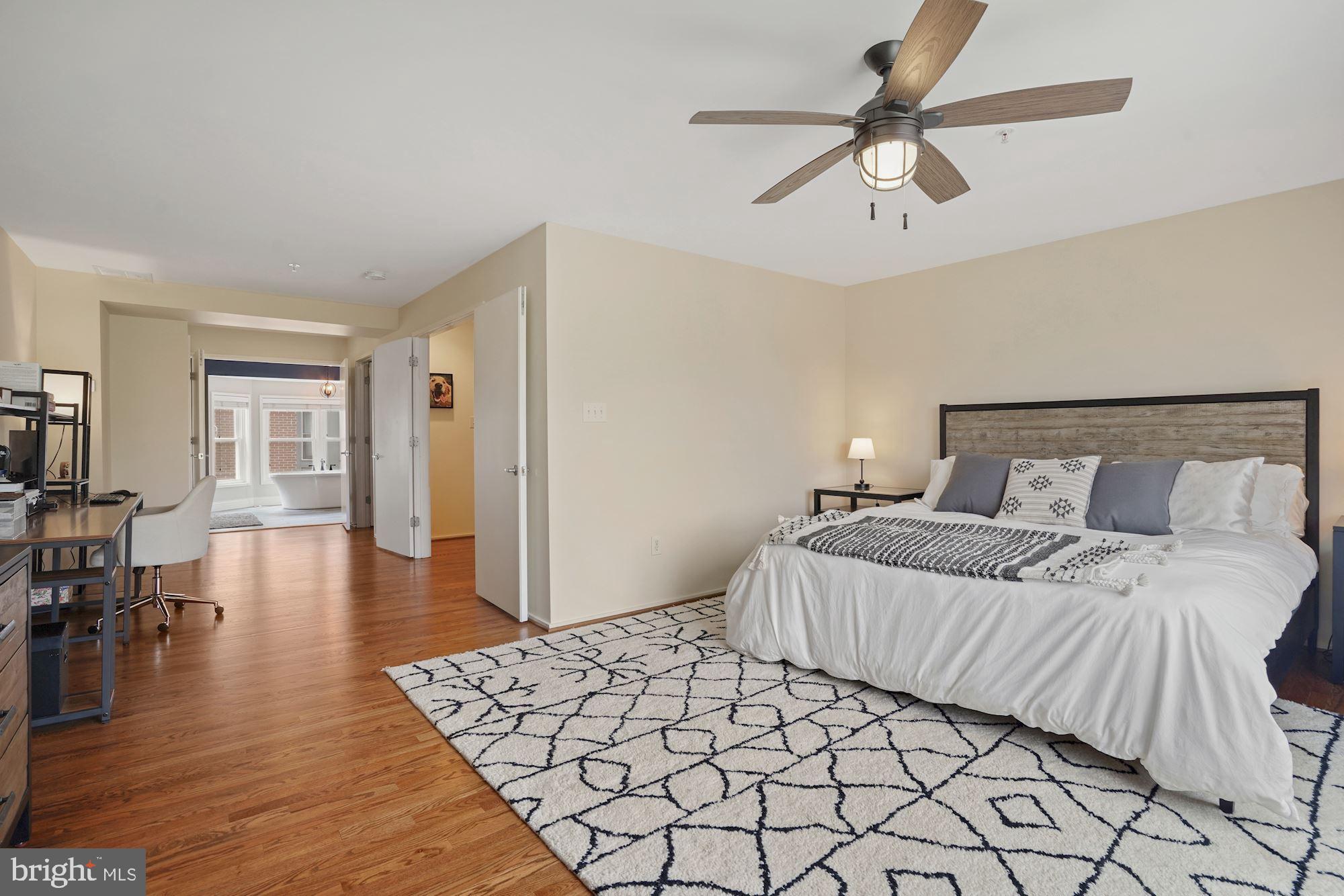 1618 North Rhodes Street Arlington, VA 22209 - Photo 17 of 33 a bedroom with a bed and wooden floor