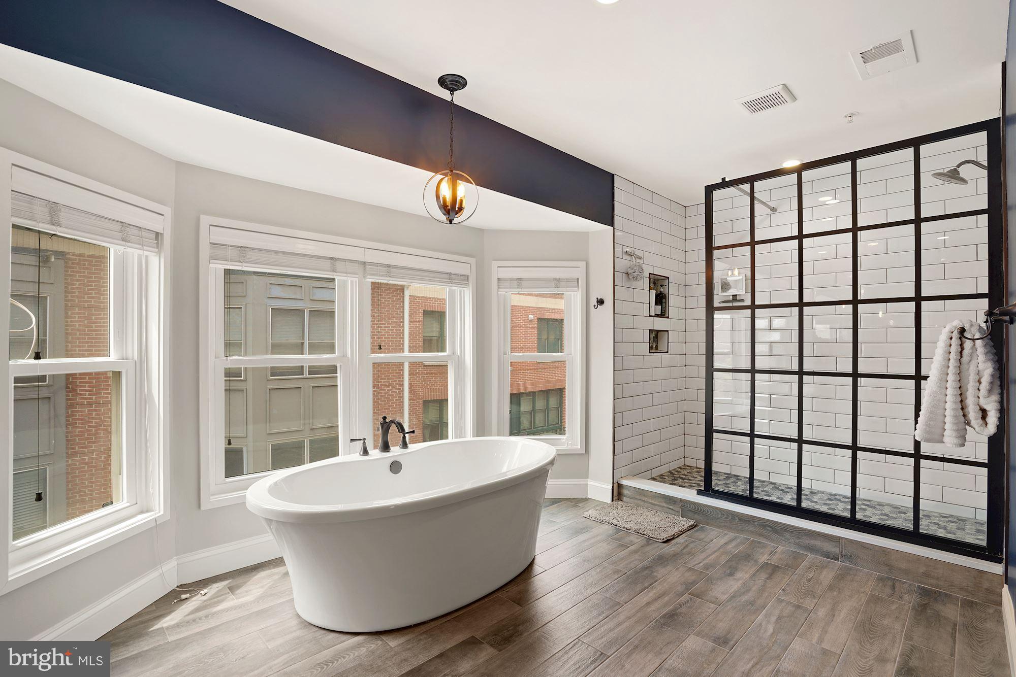 1618 North Rhodes Street Arlington, VA 22209 - Photo 20 of 33 a white bath tub sitting in front of a window