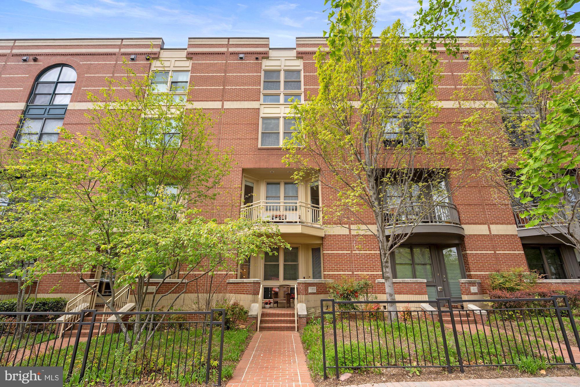 1618 North Rhodes Street Arlington, VA 22209 - Photo 2 of 33 a front view of a building with glass windows and plants
