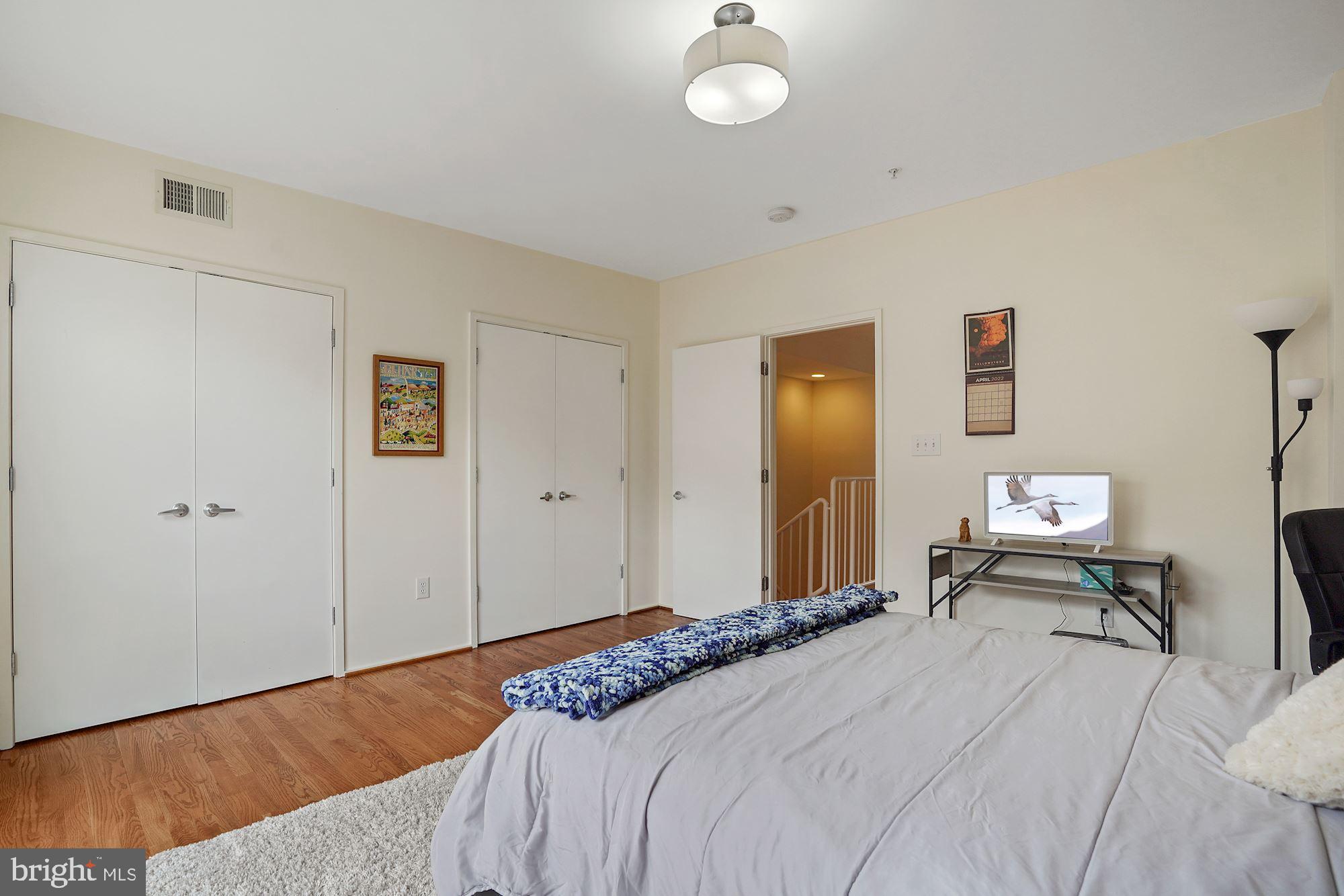 1618 North Rhodes Street Arlington, VA 22209 - Photo 24 of 33 a bedroom with a bed and a chandelier