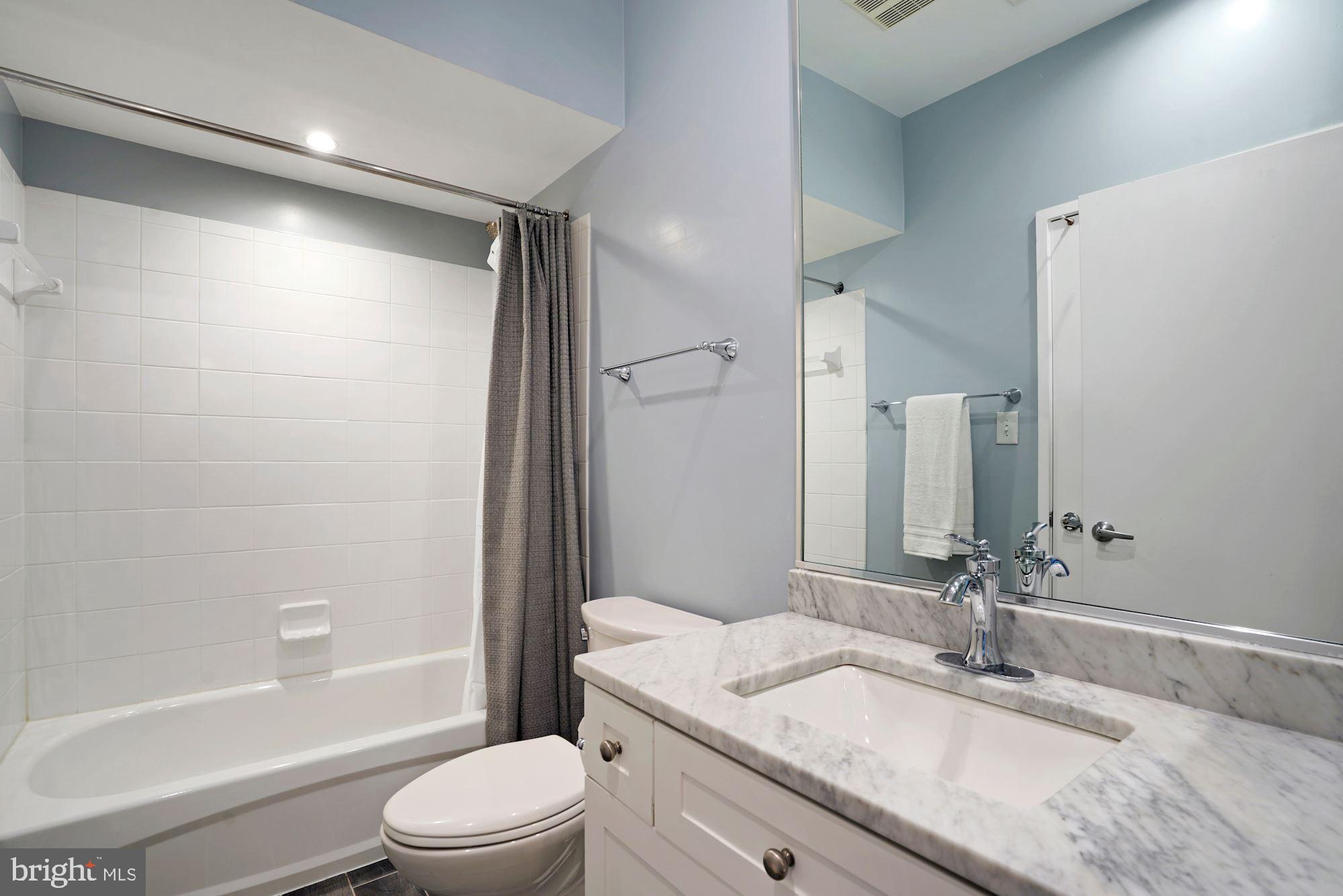 1618 North Rhodes Street Arlington, VA 22209 - Photo 26 of 33 a bathroom with a granite countertop sink toilet and shower