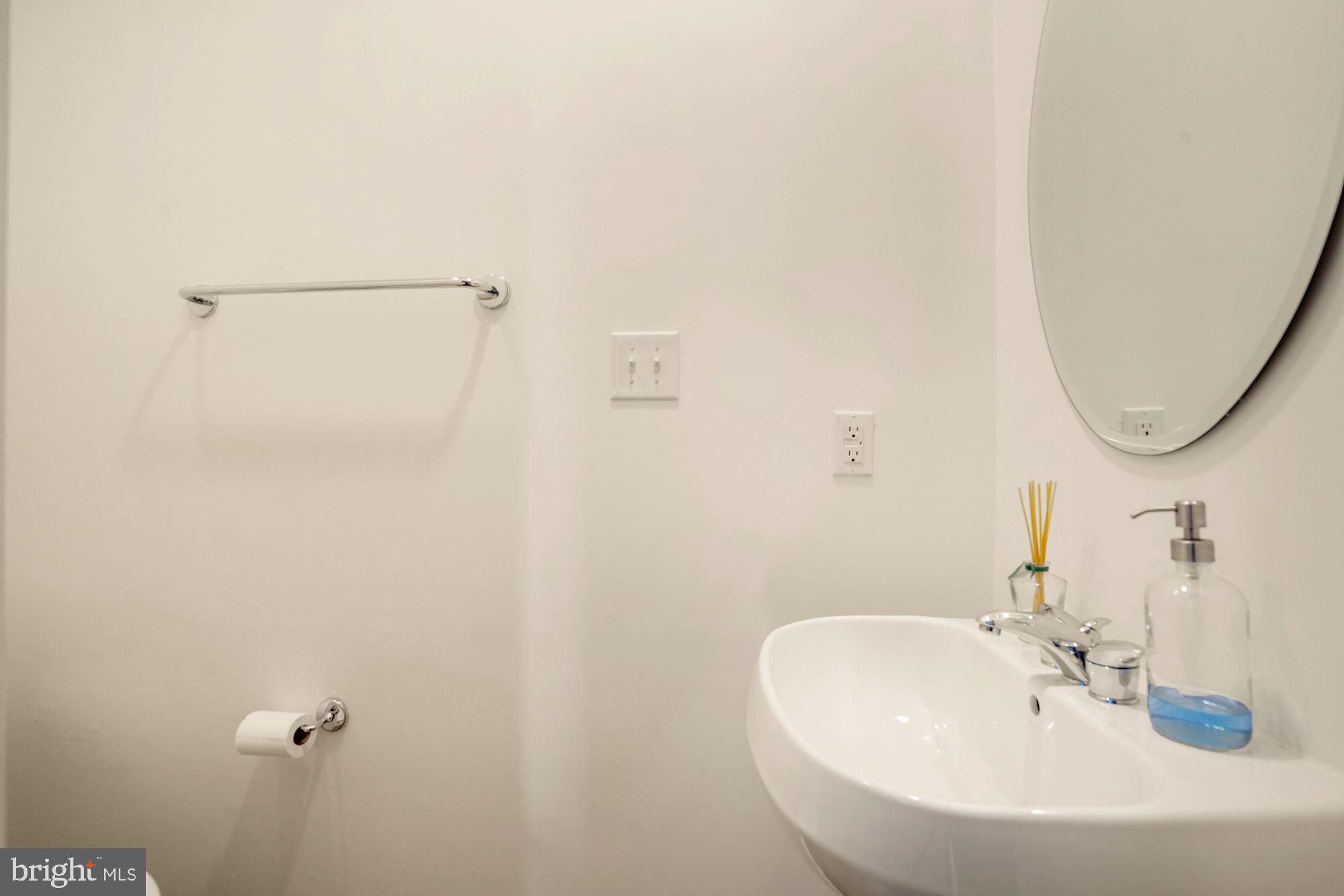 1618 North Rhodes Street Arlington, VA 22209 - Photo 29 of 33 a bathroom with a sink and a mirror