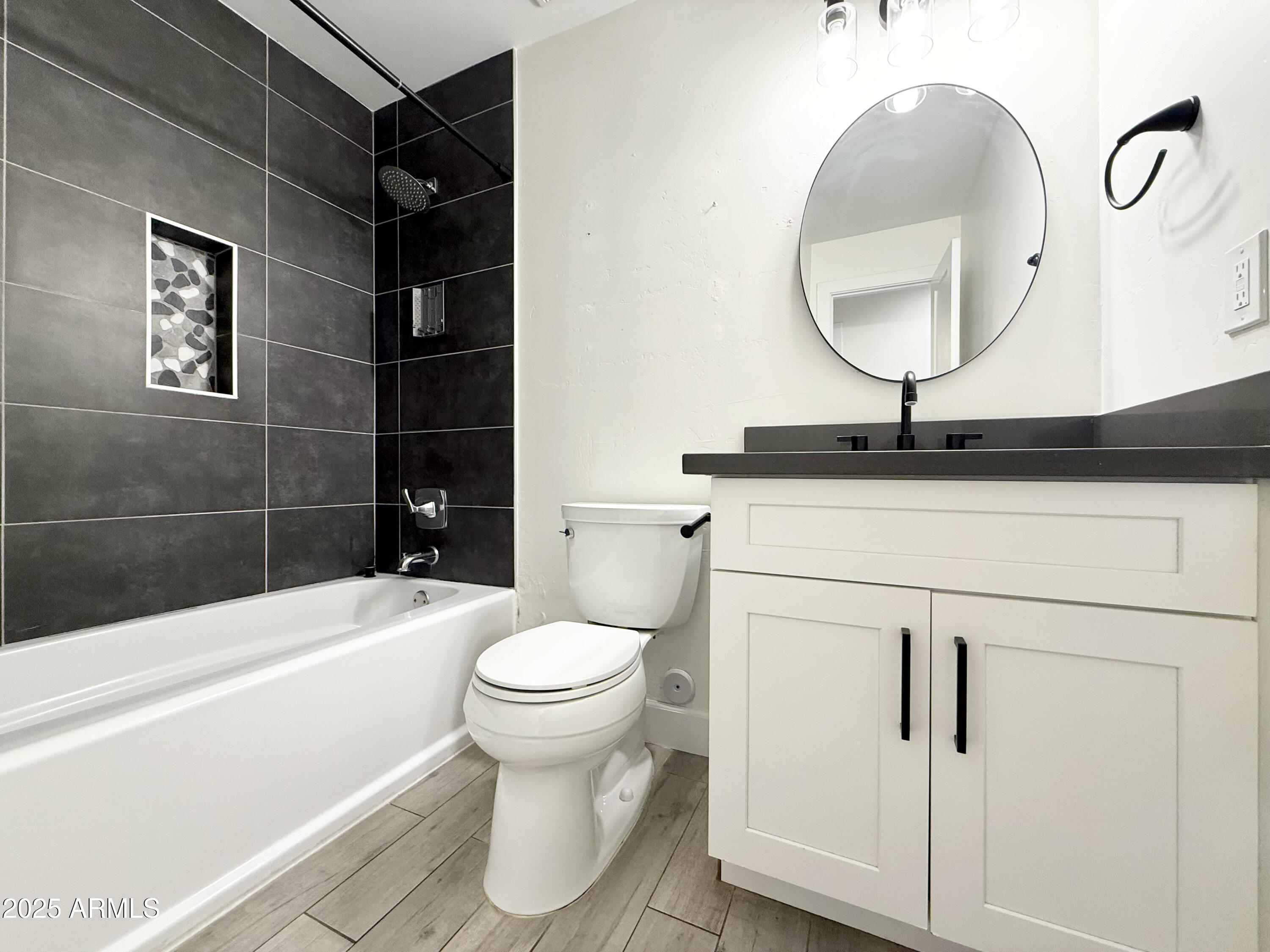 3625 North Hayden Road Scottsdale, AZ 85251 - Photo 16 of 24 a bathroom with a sink a toilet and a mirror