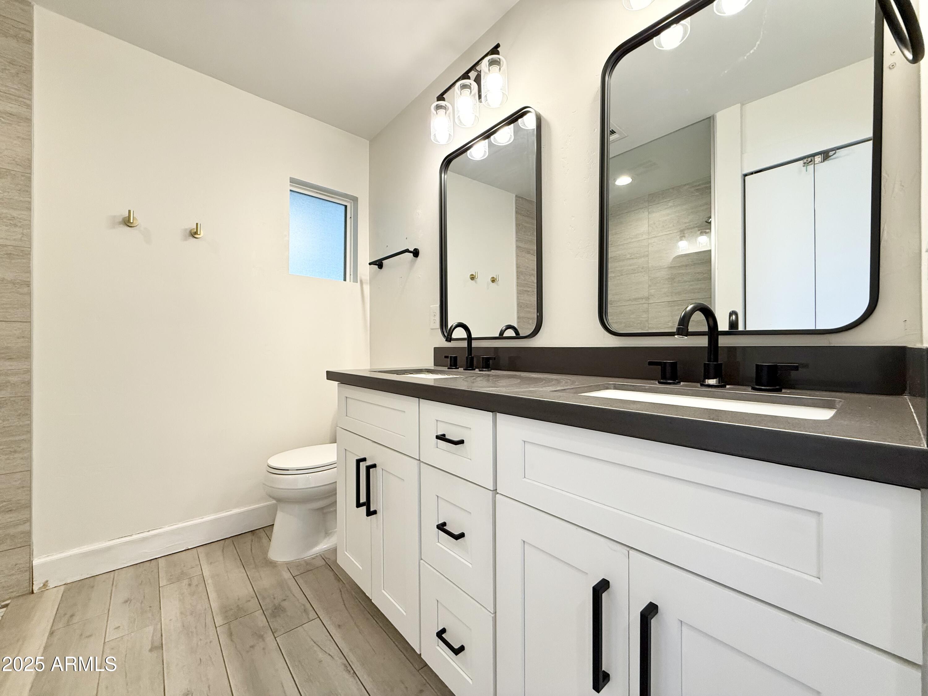3625 North Hayden Road Scottsdale, AZ 85251 - Photo 17 of 24 a bathroom with a double vanity sink and mirror