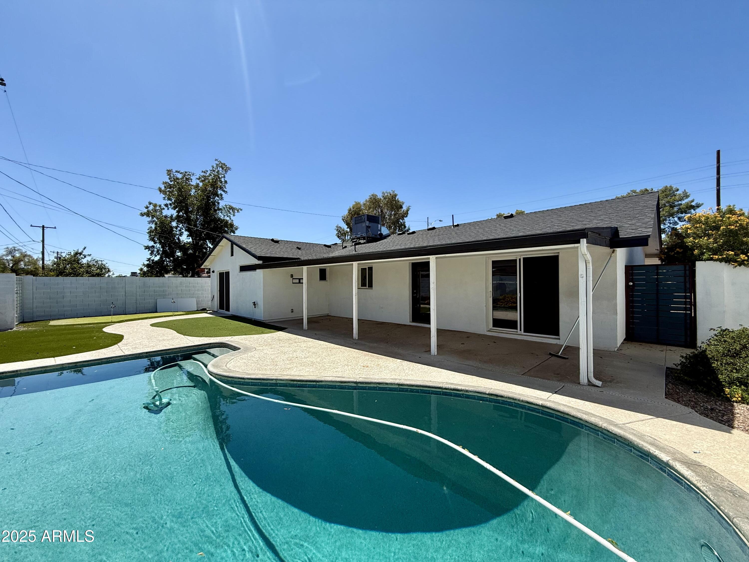 3625 North Hayden Road Scottsdale, AZ 85251 - Photo 22 of 24 a view of a house with swimming pool and sitting area