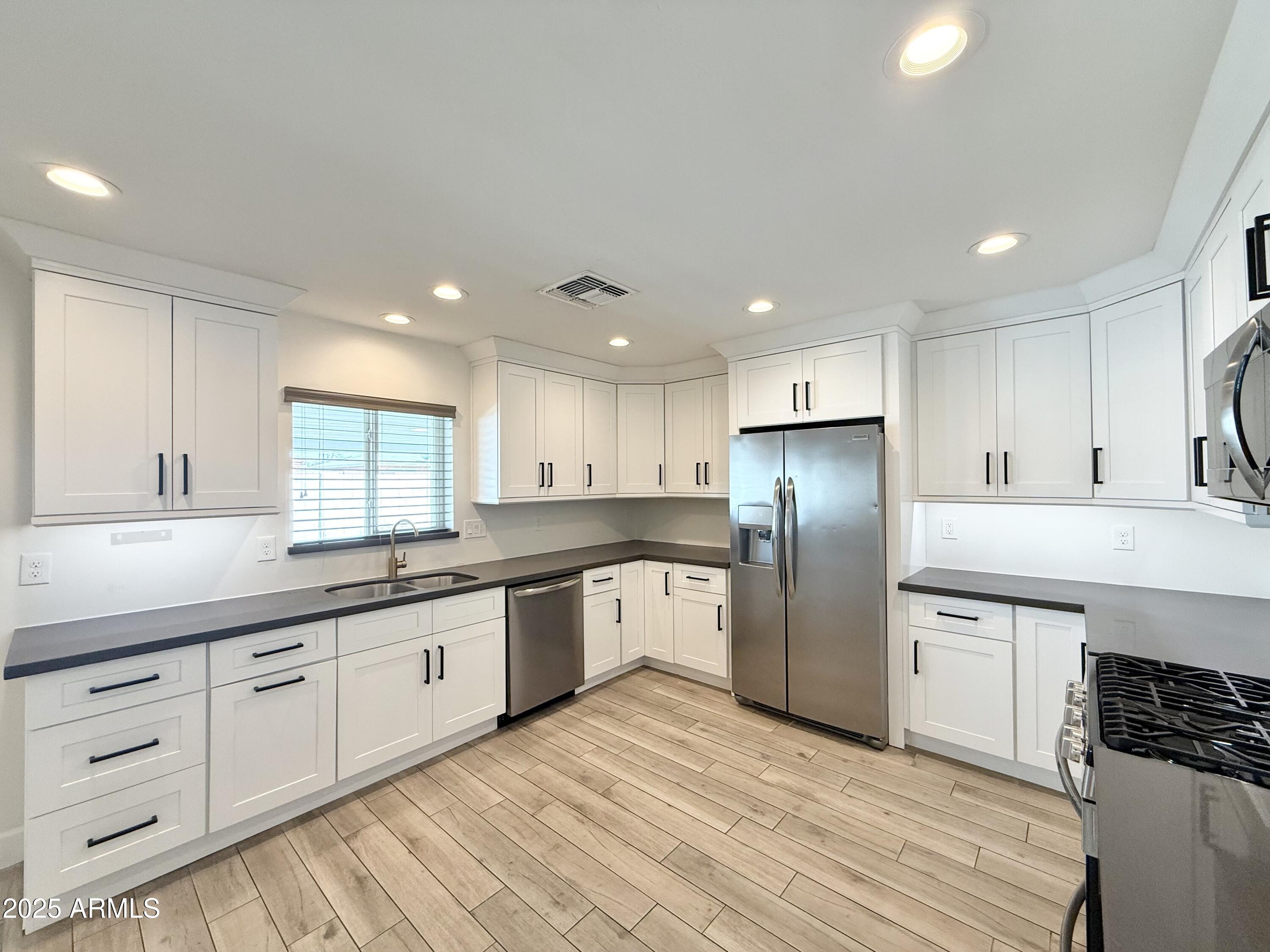 3625 North Hayden Road Scottsdale, AZ 85251 - Photo 3 of 24 a large kitchen with granite countertop a large counter top stainless steel appliances and cabinets