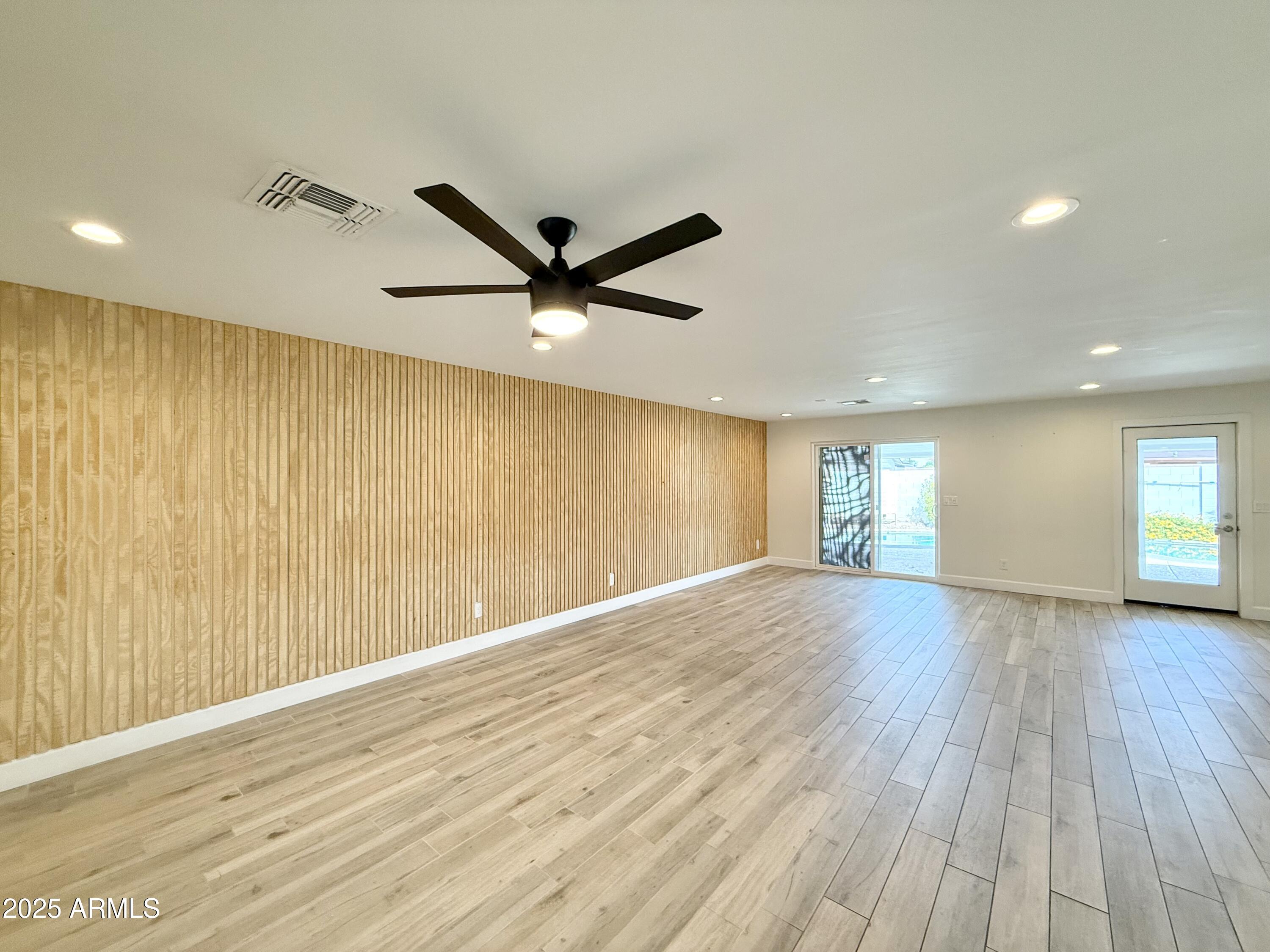 3625 North Hayden Road Scottsdale, AZ 85251 - Photo 7 of 24 an empty room with wooden floor and windows