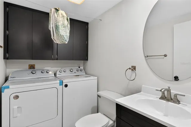 a bathroom with a granite countertop toilet and a shower