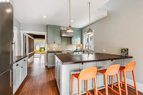 a kitchen with stainless steel appliances granite countertop a sink and wooden floors
