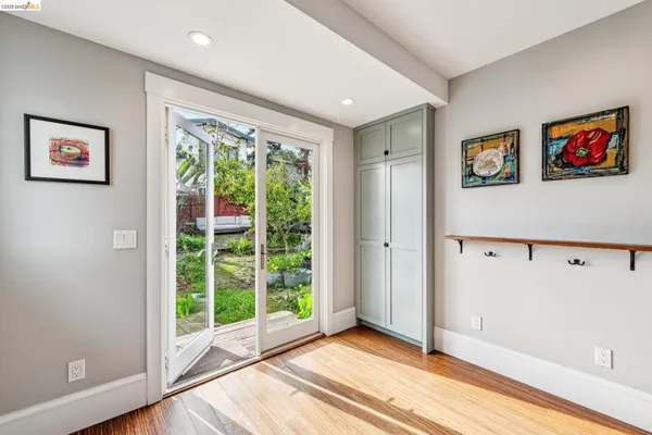 a view of a big room with wooden floor and windows