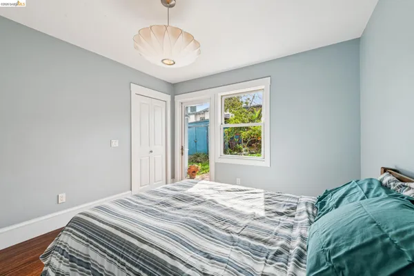 a bedroom with bed and a window