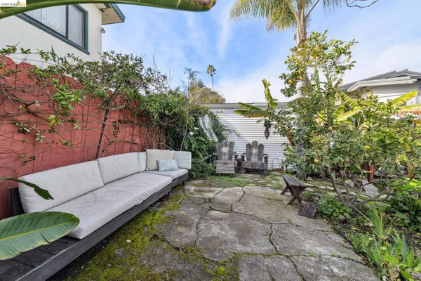 a view of a backyard with couches and swimming pool