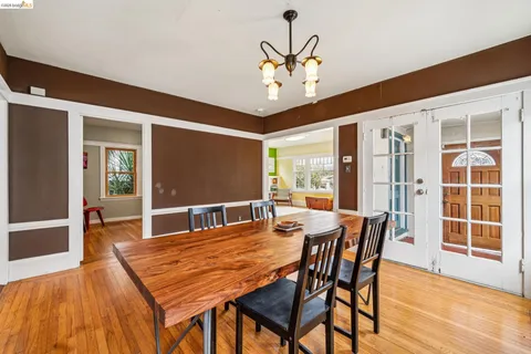 a dining room with furniture a rug and wooden floor