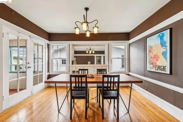 a view of a dining room with furniture window and wooden floor
