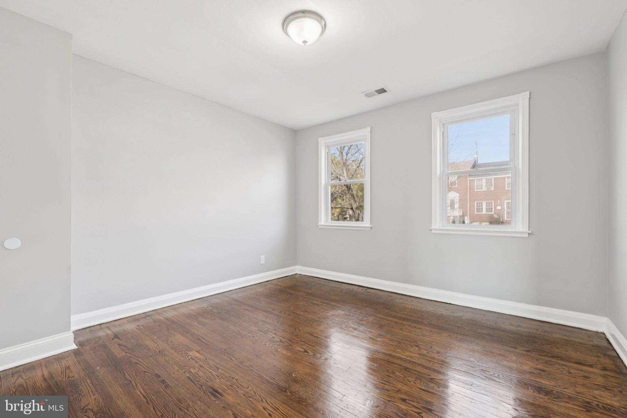 3427 Woodstock Avenue Baltimore, MD 21213 - Photo 15 of 46 a view of empty room with wooden floor and fan