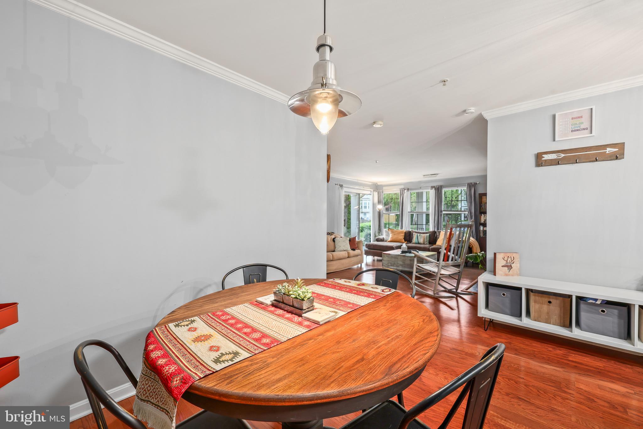 14197 Cuddy Loop, Unit 104 Woodbridge, VA 22193 - Photo 12 of 33 a living room with dining room and wooden floor