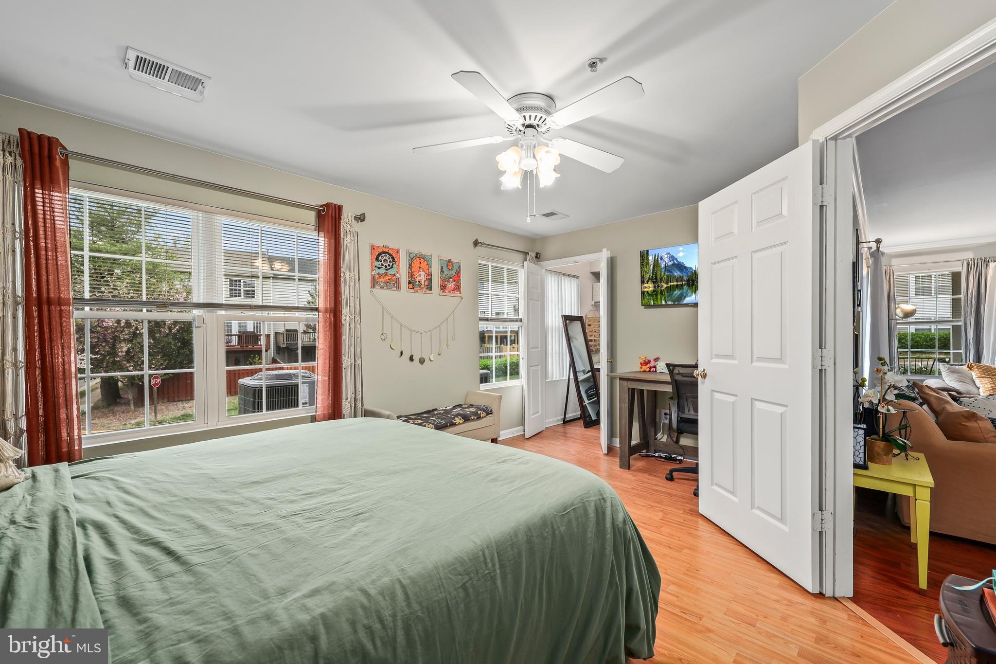 14197 Cuddy Loop, Unit 104 Woodbridge, VA 22193 - Photo 20 of 33 a bedroom with a large bed and a chandelier