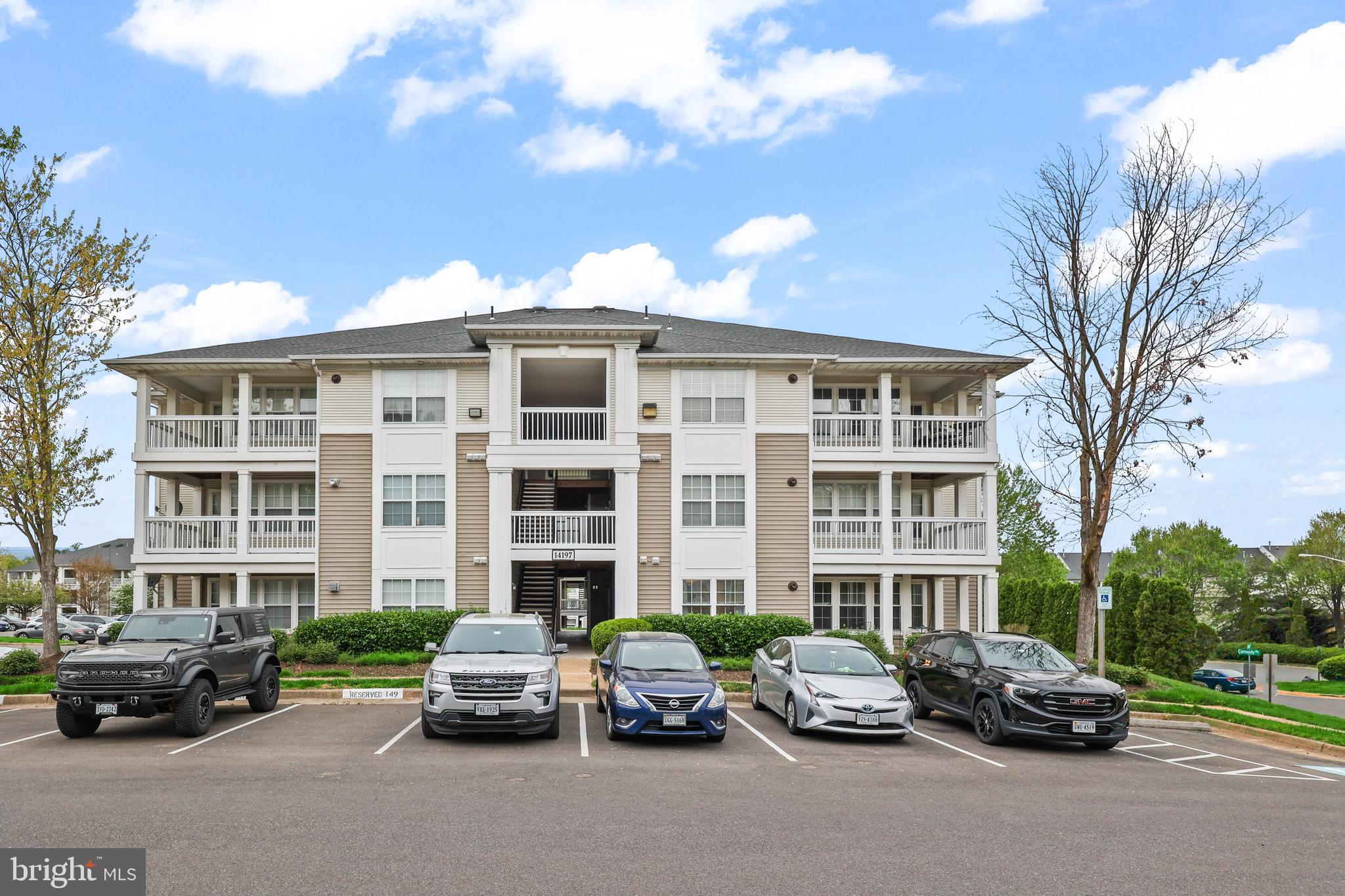 14197 Cuddy Loop, Unit 104 Woodbridge, VA 22193 - Photo 2 of 33 a car parked in front of a house