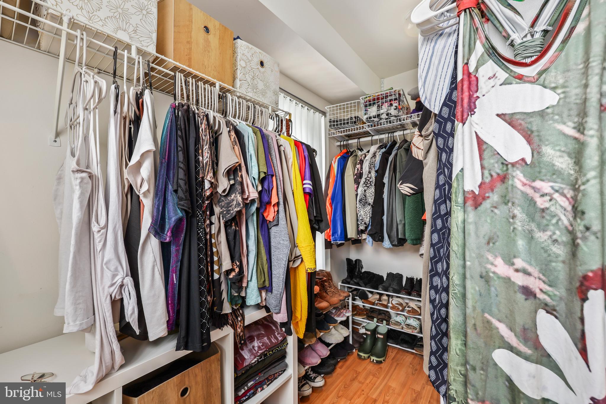 14197 Cuddy Loop, Unit 104 Woodbridge, VA 22193 - Photo 24 of 33 a view of walk in closet with clothes